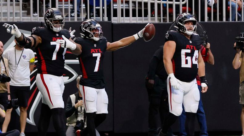 Falcons running back Bijan Robinson (center) reacts after a first down during against the Carolina Panthers at Mercedes-Benz Stadium on Sunday, Nov. 16, 2025. (Miguel Martinez/AJC)