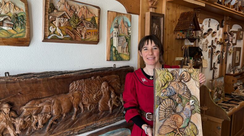 Jasmine Feuchter poses for a photo in a traditional craft shop in San Vigilio di Marebbe, northern Italy, Monday, Jan. 26, 2026. (AP Photo/Nicole Winfield)