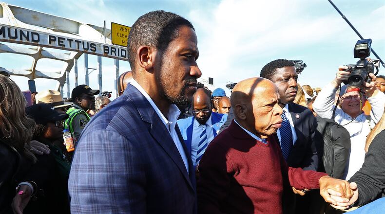 March 1, 2020 Selma: U.S. Rep. John Lewis, D-Atlanta, is helped walking from the Edmund Pettus Bridge while making an appearance and speech during Selma's er-enactment of Bloody Sunday on Sunday, March 1, 2020, in Selma. Curtis Compton ccompton@ajc.com