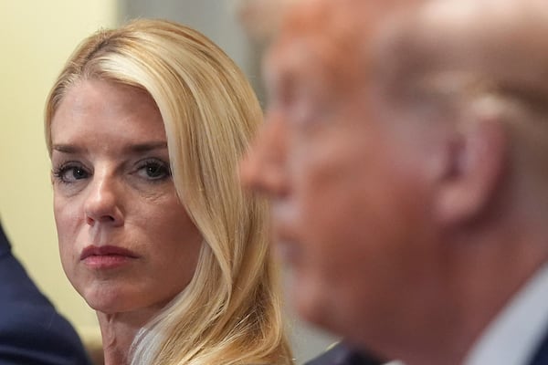 Attorney General Pam Bondi, left, listens as President Donald Trump, right, speaks during a cabinet meeting at the White House, Tuesday, July 8, 2025, in Washington. (AP Photo/Evan Vucci)