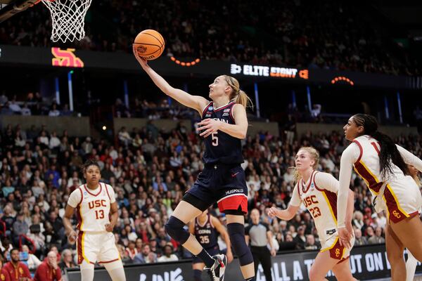 UConn guard Paige Bueckers (5) shoots during the first half against Southern California in the Elite Eight of the NCAA college basketball tournament, Monday, March 31, 2025, in Spokane, Wash. (AP Photo/Young Kwak)