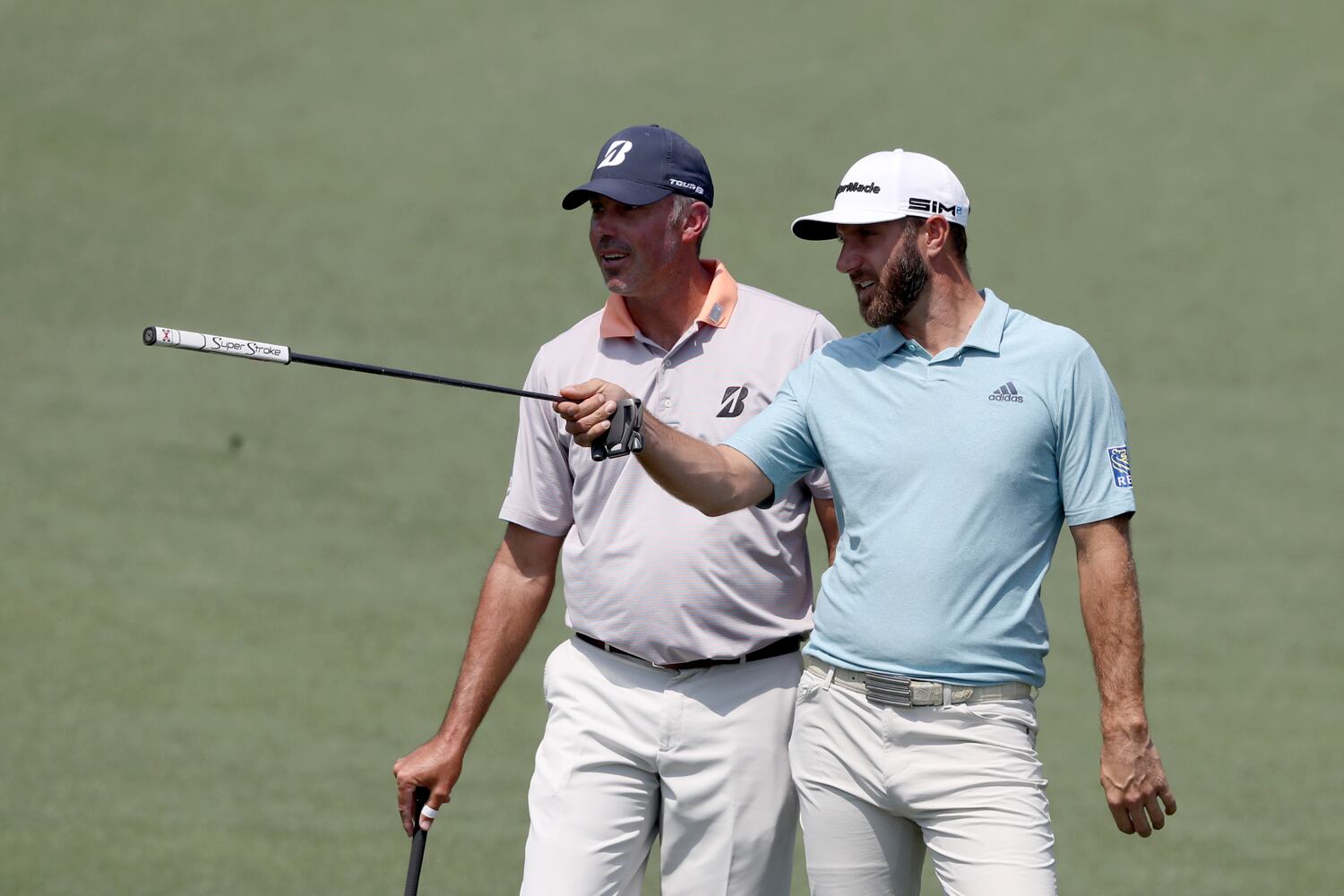 April 7, 2021, Augusta: Dustin Johnson, right, and Matt Kuchar look over a shot on the second hole during their practice round for the Masters at Augusta National Golf Club on Wednesday, April 7, 2021, in Augusta. Curtis Compton/ccompton@ajc.com