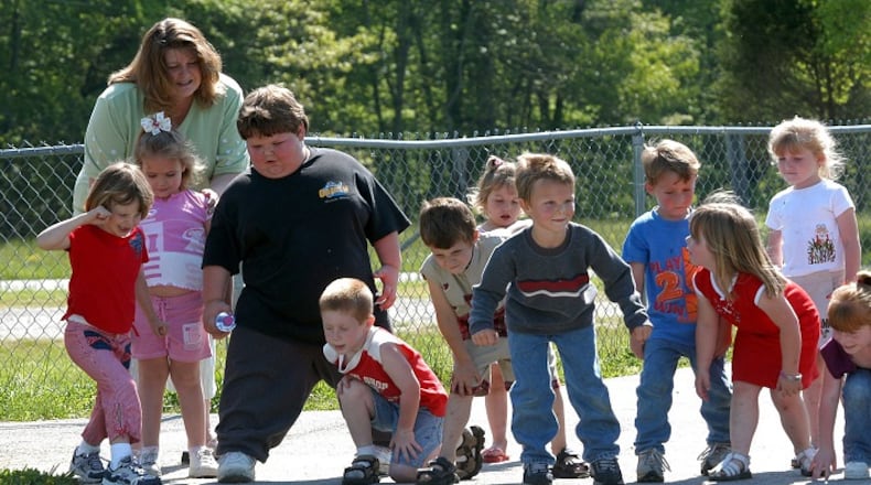 Doctors are diagnosing children in growing numbers with ailments usually seen in adults, such as hypertension, high cholesterol, Type 2 diabetes and joint problems, and they say childhood obesity is behind the trend. Here, Andy Hamblin, in black, prepares to race with his preschool classmates at Poplar Creek Elementary School in Siler, Ky., on May 6, 2004. Andy is five years old and weighs close to 188 pounds. (Charles Bertram/The Lexington Herald-Leader/MCT)