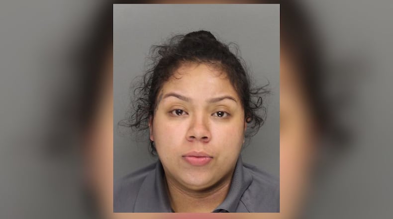 Crystal Noemi Dominguez-Carvajal faces murder and aggravated assault charges in Thursday morning's shooting at a Marietta motel.