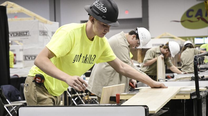 Banks Hathcox, 16, left, competes against other schools as he represents his school, Calhoun High School, during the SkillsUSA State Championship, Friday March 23, 2018, at the Georgia International Convention Center, March 23, 2018. (John Amis)