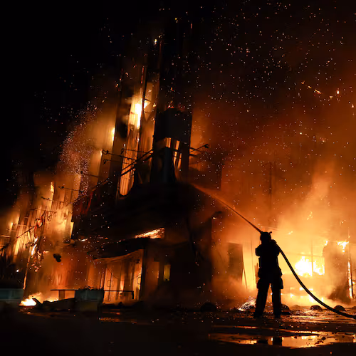 A rescue worker puts out a fire at the Intrade trade center after a Russian drone strike on Zaporizhzhia, Ukraine, Monday, Sept. 21, 2026. (AP Photo/Kateryna Klochko) Correction: Byline corrected to Kateryna Klochko, instead of Evgeniy Maloletka