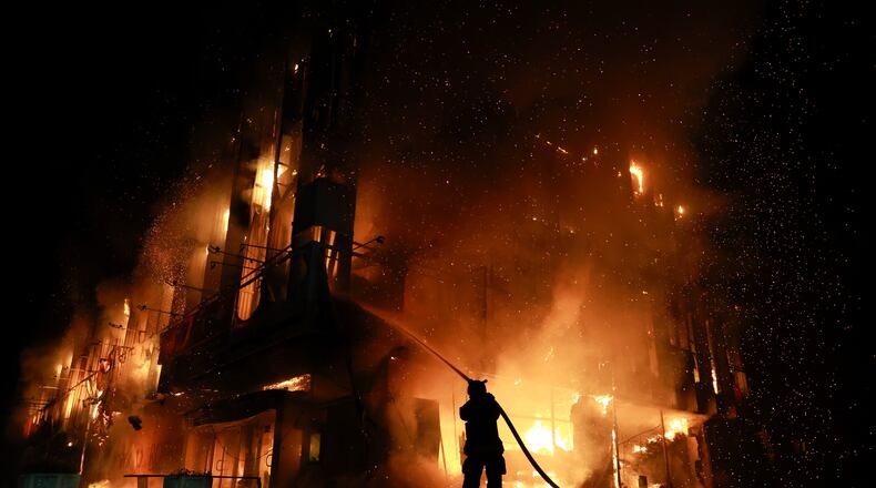 A rescue worker puts out a fire at the Intrade trade center after a Russian drone strike on Zaporizhzhia, Ukraine, Monday, Sept. 21, 2026. (AP Photo/Kateryna Klochko) Correction: Byline corrected to Kateryna Klochko, instead of Evgeniy Maloletka