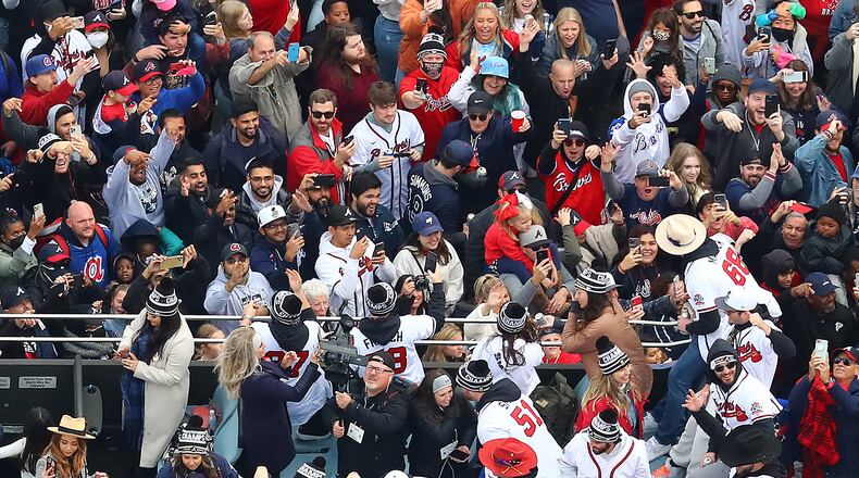 110521 ATLANTA: Players party with fans from the top of a double decker bus arriving in the Battery as the Atlanta Braves host a World Series Championship Parade and celebration on Friday, Nov. 5, 2021, in Atlanta. “Curtis Compton / Curtis.Compton@ajc.com”
