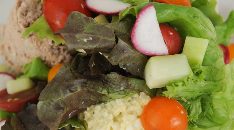 Southern Bistro three salad plate with egg, chicken and tuna salad, baby mixed greens, tomatoes, cucumbers and radishes. BECKY STEIN PHOTOGRAPHY