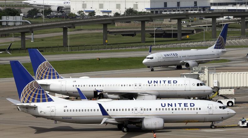 In this July 8, 2015, file photo, a United Airlines plane, front, is pushed back from a gate at George Bush Intercontinental Airport in Houston. (AP Photo/David J. Phillip, File)