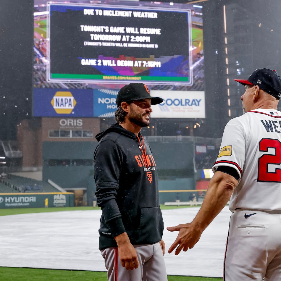 Giants manager Tony Vitello (left) speaks with Braves manager Walt Weiss after their game was suspended because of weather on Tuesday, June 16, 2026, in Atlanta. (Erik S. Lesser/AP)