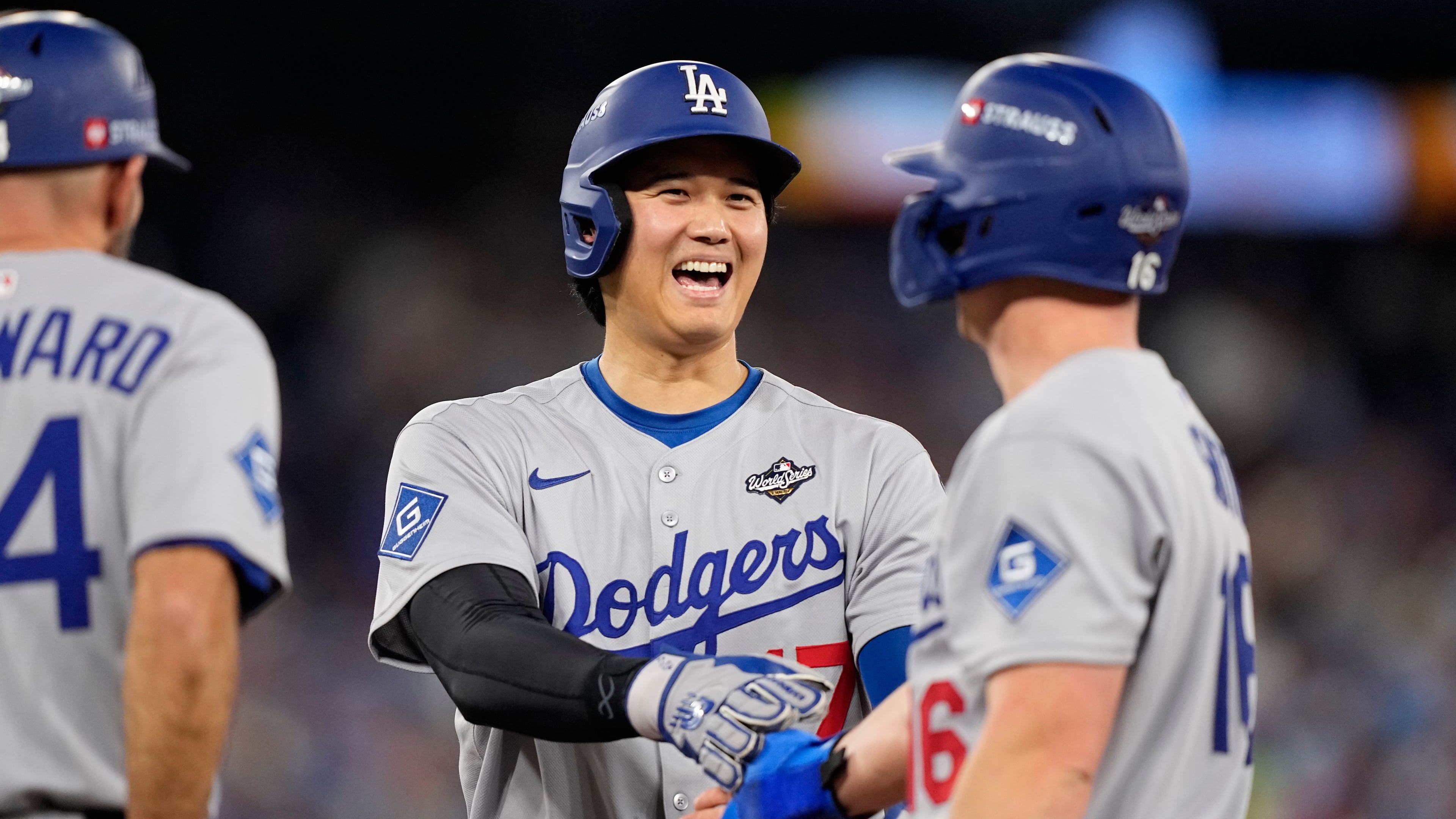 Los Angeles Dodgers' Shohei Ohtani and Will Smith talk during the eighth inning in Game 6 of baseball's World Series against the Toronto Blue Jays, Friday, Oct. 31, 2025, in Toronto. (AP Photo/Brynn Anderson)