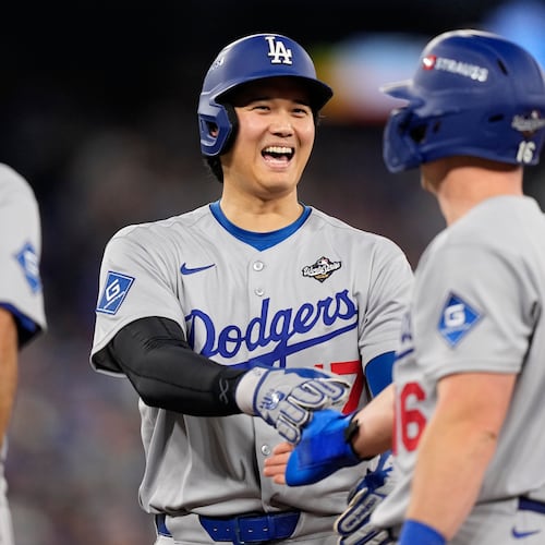 Los Angeles Dodgers' Shohei Ohtani and Will Smith talk during the eighth inning in Game 6 of baseball's World Series against the Toronto Blue Jays, Friday, Oct. 31, 2025, in Toronto. (AP Photo/Brynn Anderson)