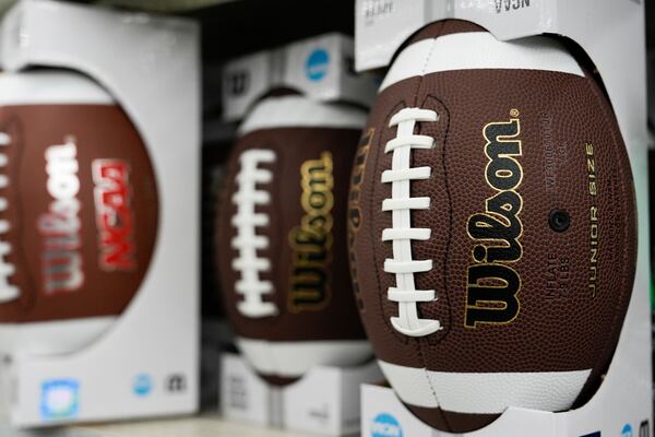 Footballs are displayed on shelves at a Walmart, Wednesday, April 16, 2025, in Groton, Conn. (AP Photo/Julia Demaree Nikhinson)