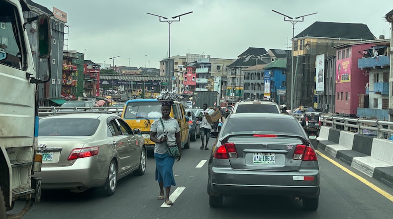 People sell their merchandise during rush hour traffic in Lagos, Nigeria, Tuesday, Aug. 18, 2026. (AP Photo/Sunday Alamba)