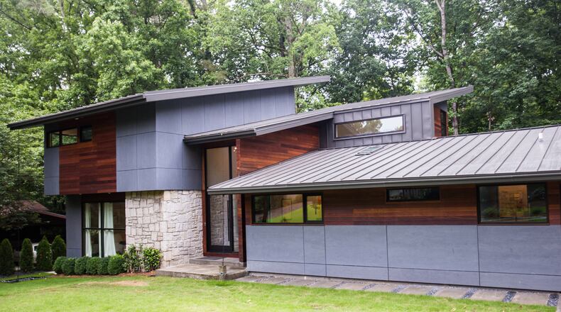 Dan Kaufman and his family live in a classic brick ranch in Chastain Park that has been modernized into a contemporary space with dozens of windows, open staircases, metal roof, pool and basketball court.