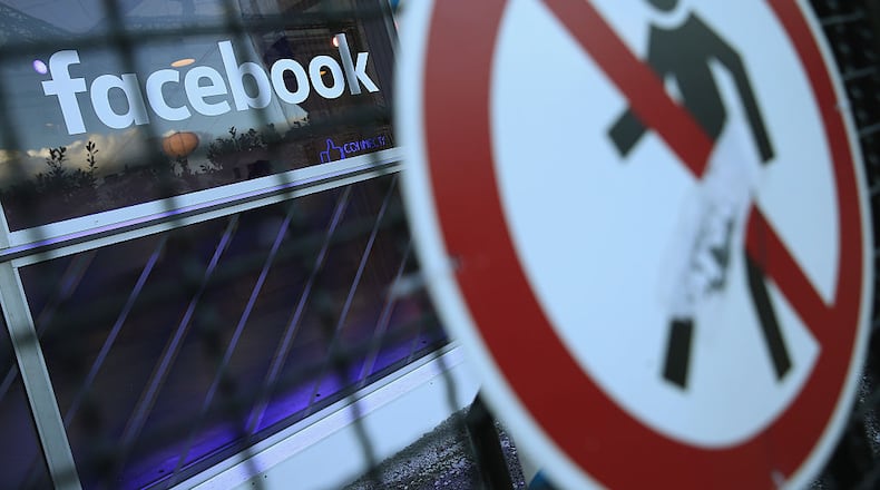 BERLIN, GERMANY - FEBRUARY 24: A no entry symbol hangs on an opened gate next to the Facebook logo at the Facebook Innovation Hub on February 24, 2016 in Berlin, Germany. The Facebook Innovation Hub is a temporary exhibition space where the company is showcasing some of its newest technologies and projects. (Photo by Sean Gallup/Getty Images)