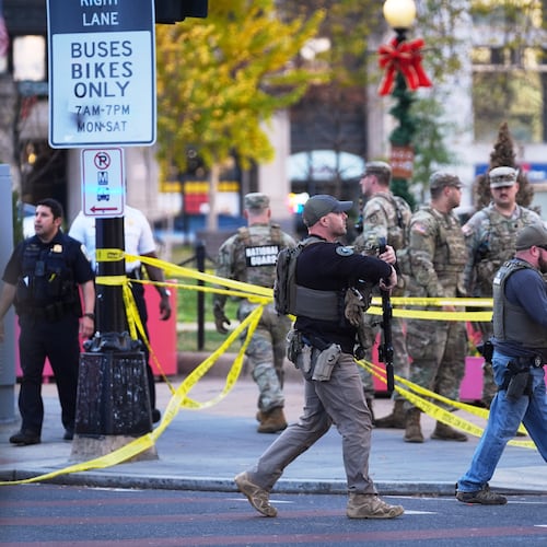 U.S. Marshalls and National Guard troops are seen after reports of two National Guard soldiers shot near the White House in Washington, Wednesday, Nov. 26, 2025. (AP Photo/Evan Vucci)