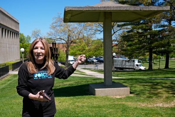 FILE - Chic Canfora recounts the events of May 4, 1970, standing at the pagoda where National Guardsmen knelt and shot towards students in the parking lot at rear, during an interview Thursday, May 2, 2024, in Kent, Ohio. (AP Photo/Sue Ogrocki, File)