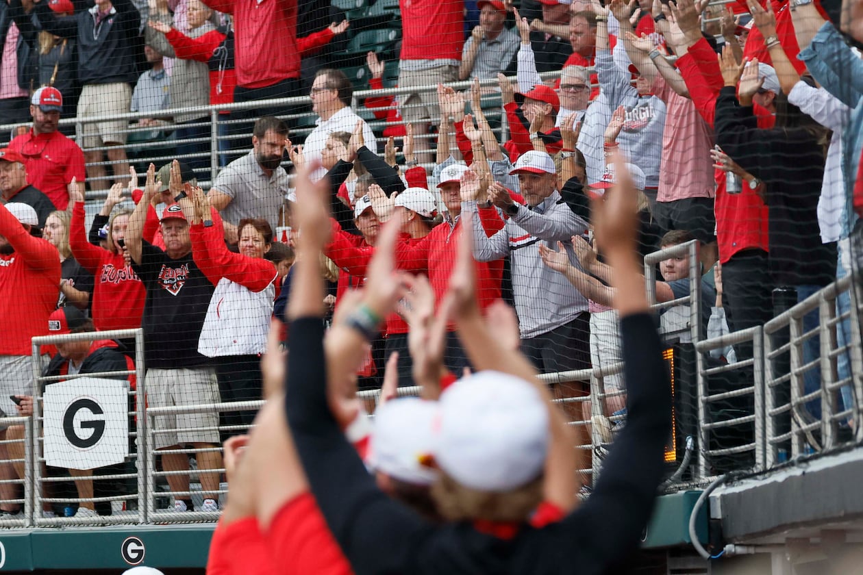 Georgia Bulldogs fans and players cheer as Liberty Flames exchange pitchers during the sixth inning of their NCAA Regional final game at Foley Field on Sunday, May 31, 2026, in Athens.(Miguel Martinez/AJC)