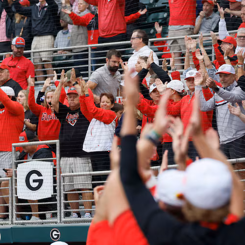 Georgia Bulldogs fans and players cheer as Liberty Flames exchange pitchers during the sixth inning of their NCAA Regional final game at Foley Field on Sunday, May 31, 2026, in Athens.(Miguel Martinez/AJC)