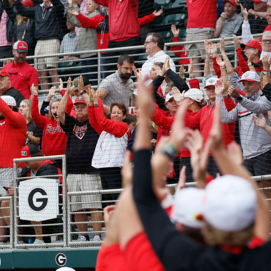 Georgia Bulldogs fans and players cheer as Liberty Flames exchange pitchers during the sixth inning of their NCAA Regional final game at Foley Field on Sunday, May 31, 2026, in Athens.(Miguel Martinez/AJC)