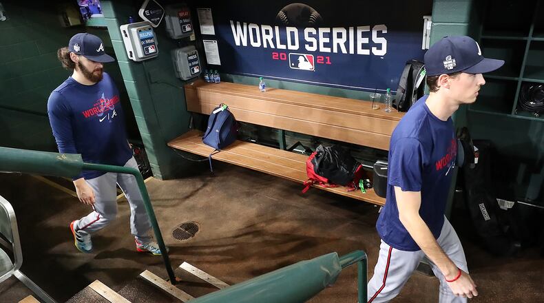 Braves pitchers Ian Anderson (left) and Max Fried walk through the dugout arriving for team practice Monday, Oct. 25, 2021, at Minute Maid Park the day before playing the Astros in Game 1 of the World Series in Houston. (Curtis Compton / Curtis.Compton@ajc.com)
