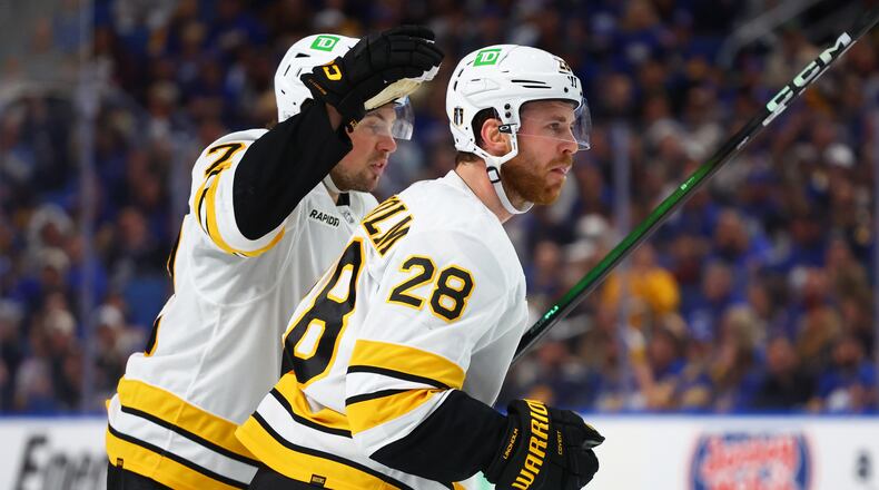 Boston Bruins center Elias Lindholm (28) celebrates his goal with defenseman Charlie McAvoy (73)during the second period in Game 5 of a first-round NHL hockey Stanley Cup playoff series against the Buffalo Sabres Tuesday, April 28, 2026, in Buffalo, N.Y. (AP Photo/Jeffrey T. Barnes)