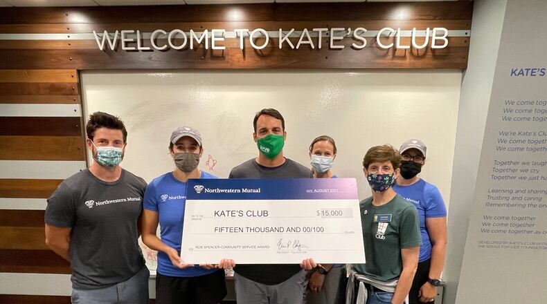 Rob Spencer (center) presents a $15,000 donation to Kate's Club from an award he received through his company for volunteer service.
