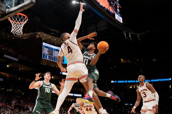 Michigan State guard Jase Richardson (11) shoots against Auburn forward Johni Broome (4) during the second half in the Elite Eight of the NCAA college basketball tournament, Sunday, March 30, 2025, in Atlanta. (AP Photo/George Walker IV)