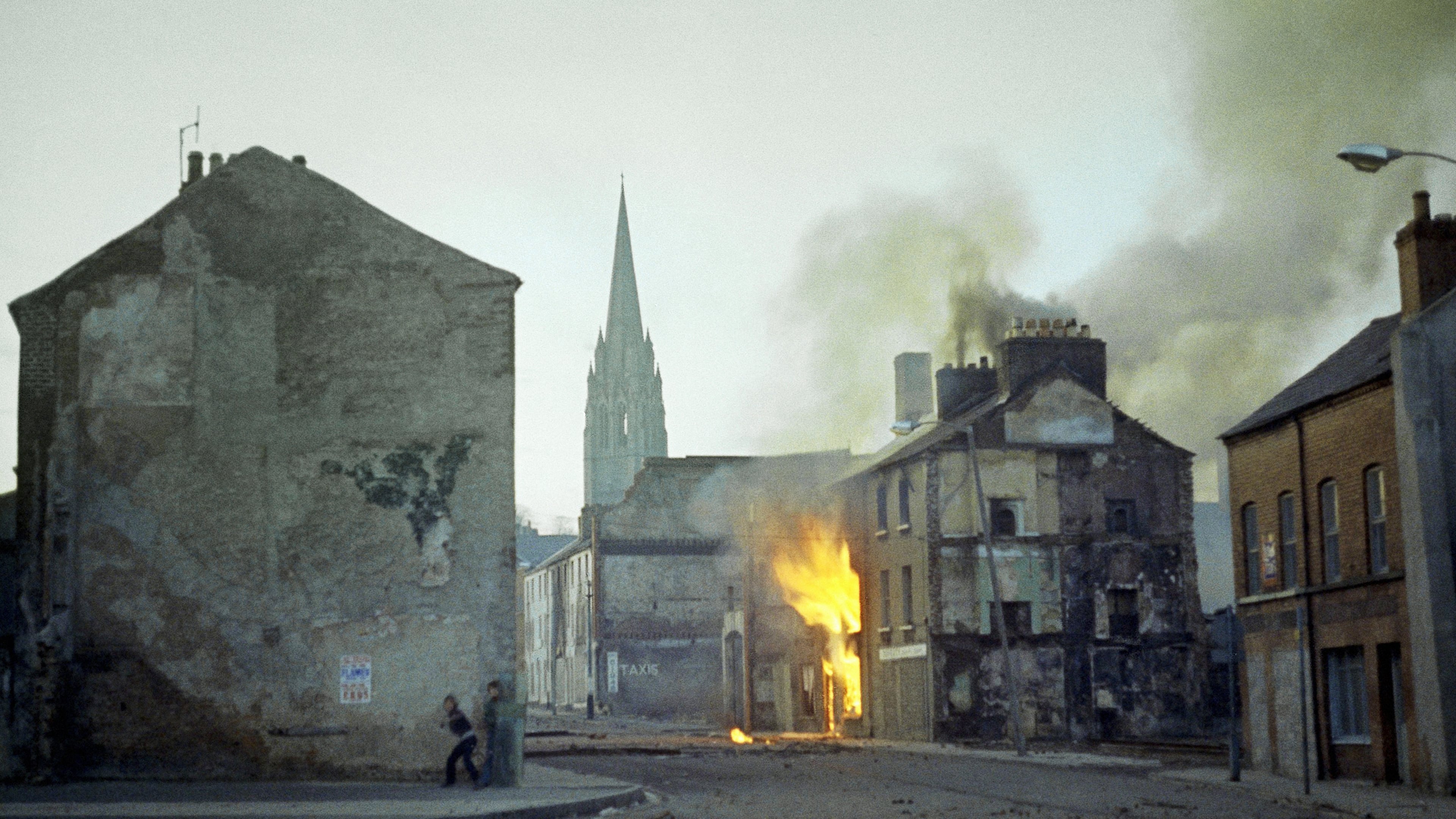 FILE - A building burns in the bogside district of Londonderry, Northern Ireland, in the aftermath of Bloody Sunday, in February 1972. (AP Photo/Michel Laurent, File)
