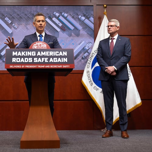 Transportation Secretary Sean Duffy speaks as Derek Barrs, Administrator of the Federal Motor Carrier Safety Administration, listens during a news conference at the Department of Transportation in Washington, Friday, Dec. 12, 2025. (AP Photo/Mark Schiefelbein)