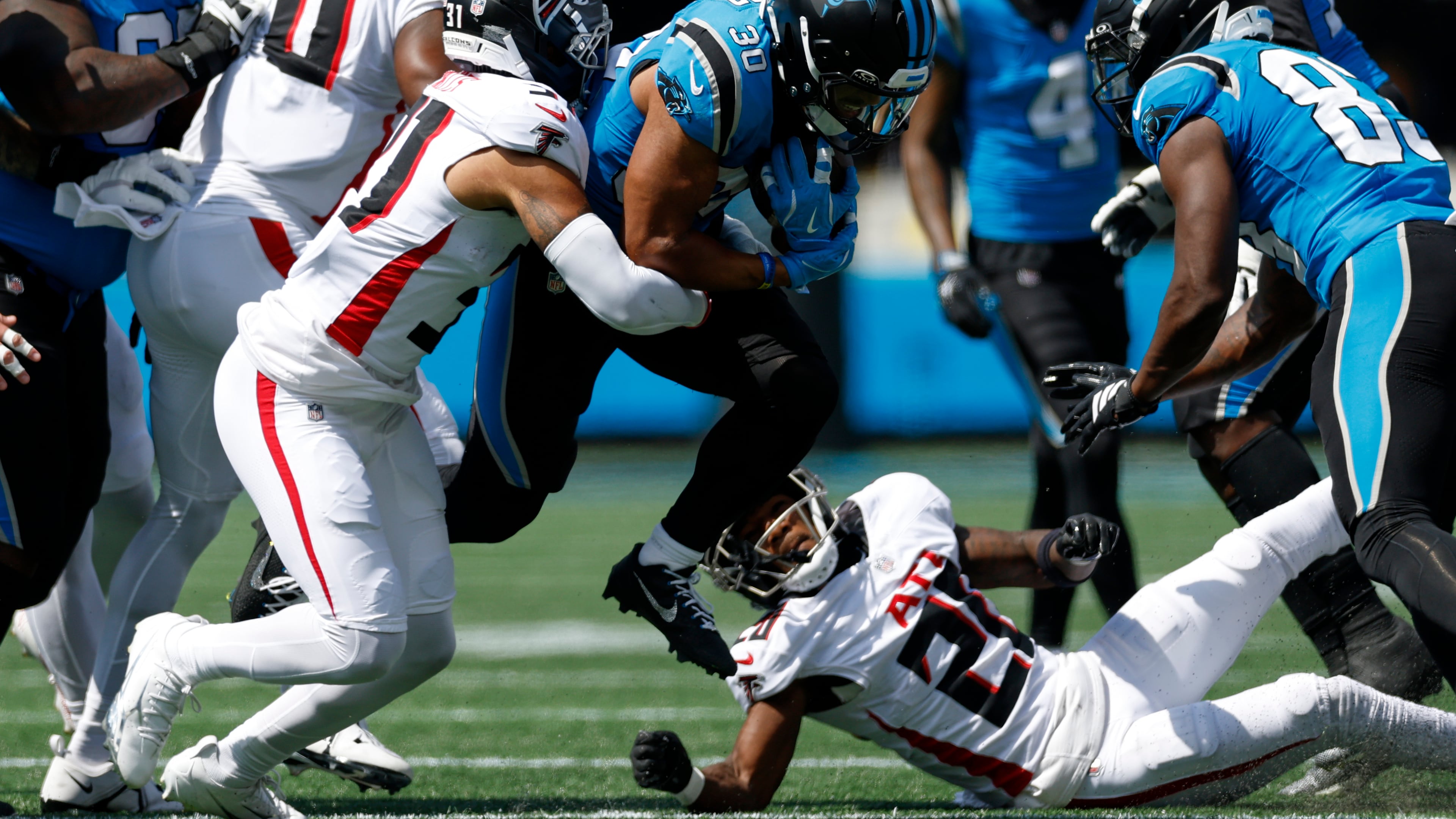 Carolina Panthers running back Chuba Hubbard is tackled by Atlanta Falcons safety Xavier Watts during the first half of an NFL football game, Sunday, Sept. 21, 2025, in Charlotte, N.C. (AP Photo/Rusty Jones)