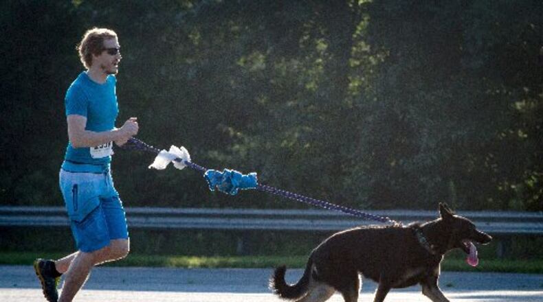 Andrew Knrdeiski and his dog Minna run during the Fast and Furry 5K fun run at Cobb County Animal Control in Marietta, GA Saturday morning June 30, 2018.