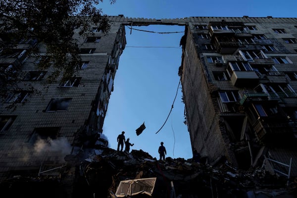 Rescue workers clear the rubble of a multi-storey residential house destroyed by a Russian strike in Kyiv, Ukraine, on Tuesday, June 17, 2025. (AP Photo/Evgeniy Maloletka)