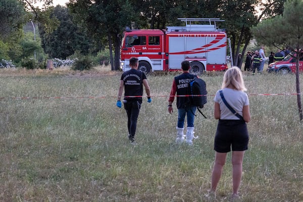 A firefighter truck and forensic police work at the site of the discovery of the body of an infant and the infant’s mother, in Rome’s Villa Pamphili park, Saturday, June 7, 2025. (Francesco Benvenuti/LaPresse via AP)