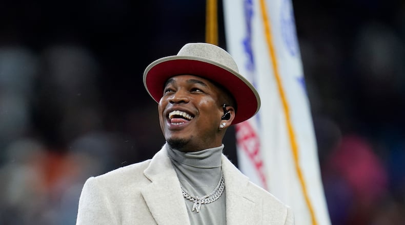 Ne-Yo smiles after singing the national anthem before an NFL football game between the Detroit Lions and Chicago Bears in Detroit, Thursday, Nov. 25, 2021. (AP Photo/Paul Sancya)