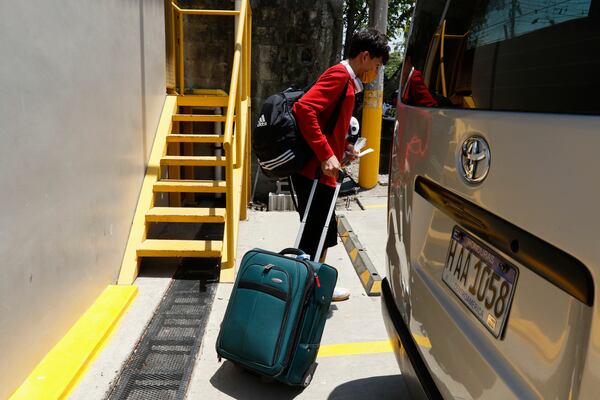 A Honduran migrant who returned voluntarily from the United States walks after arriving at Ramon Villeda Morales Airport in San Pedro Sula, Honduras, Monday, May 19, 2025. (AP Photo/Delmer Martinez)