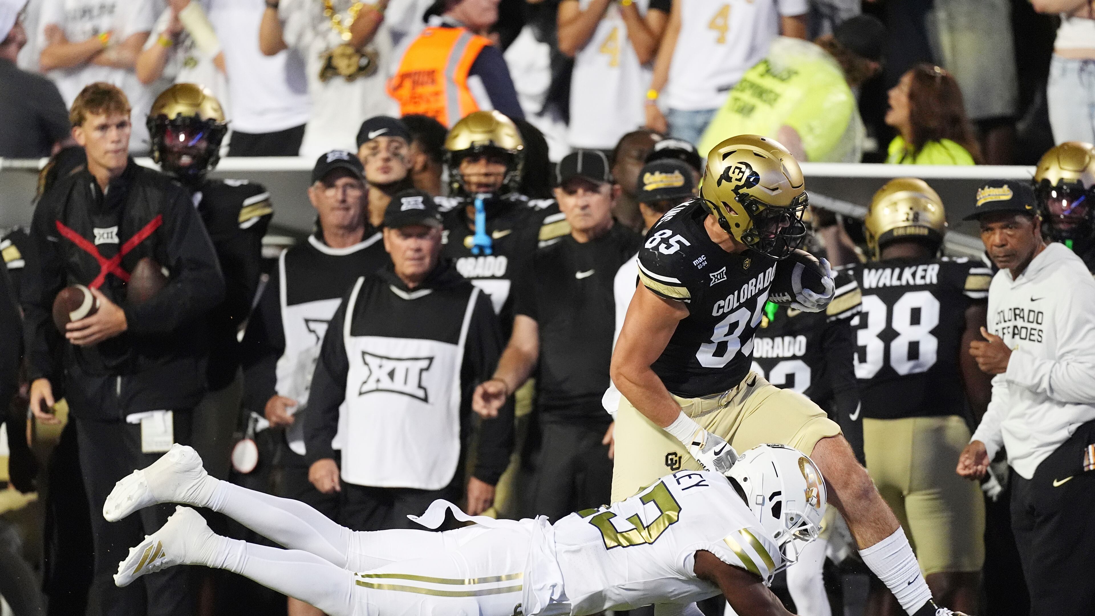 Georgia Tech defensive back Savion Riley, front, tackles Colorado tight end Zach Atkins after he pulled in a pass in the second half of an NCAA college football game, Friday, Aug. 29, 2025, in Boulder, Colrado. (David Zalubowski/AP)