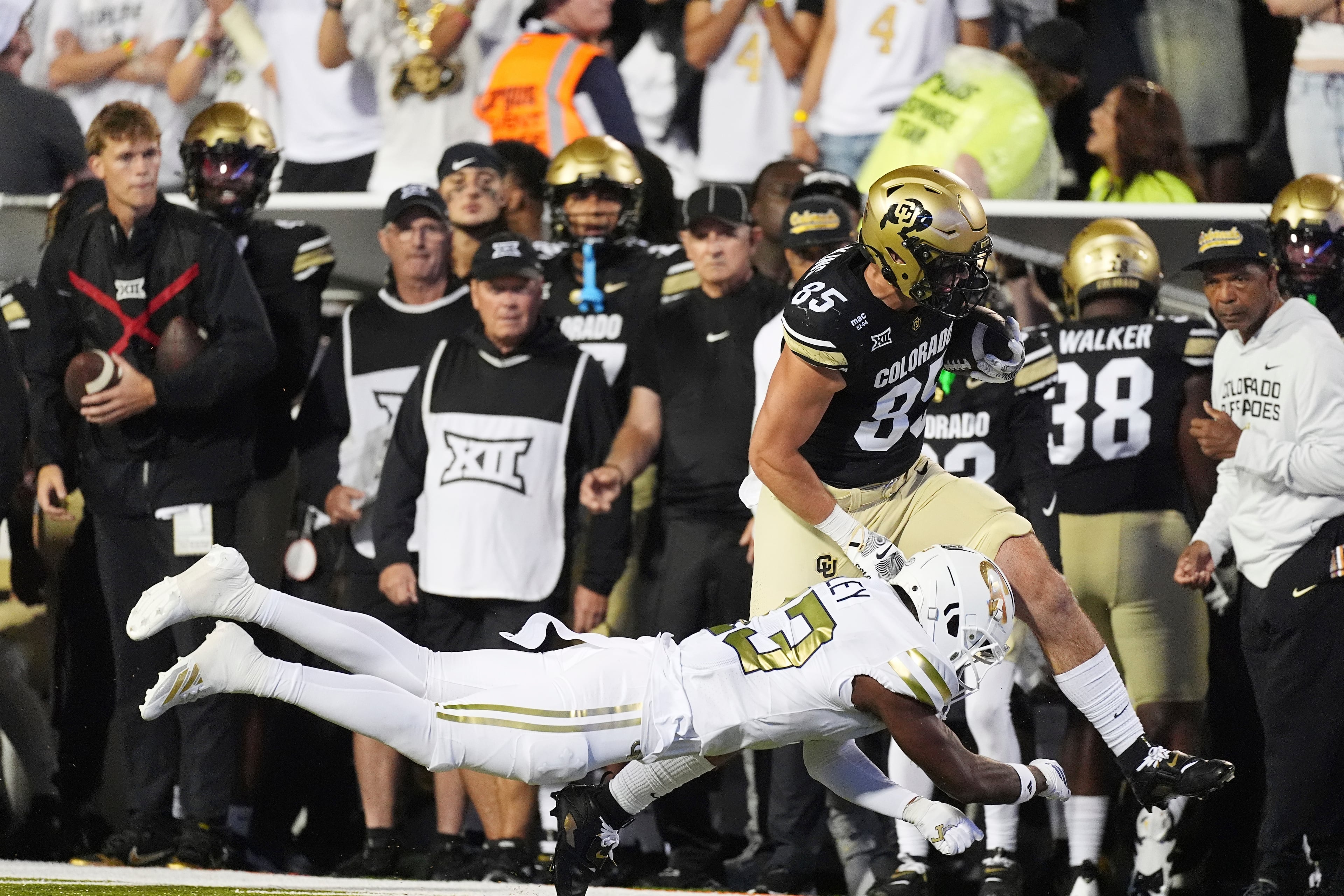 Georgia Tech defensive back Savion Riley, front, tackles Colorado tight end Zach Atkins after he pulled in a pass in the second half of an NCAA college football game, Friday, Aug. 29, 2025, in Boulder, Colo. (AP Photo/David Zalubowski)