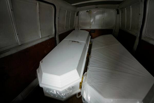The coffin on the left that contains the remains of a son of Carlos Severino, sits next to an empty coffin that will be used for the remains of another son of Severino, who lost three sons when the Jet Set nightclub roof collapsed, outside the morgue of the National Institute of Forensic Pathology in Santo Domingo, Dominican Republic, Friday, April 11, 2025. (AP Photo/Matias Delacroix)
