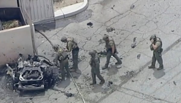 Law enforcement investigate a vehicle after an explosion on Saturday, May 17, 2025 in Palm Springs, Calif. (ABC7 Los Angeles via AP)