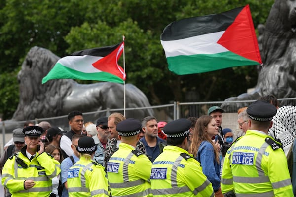 Demonstrators pass aline of police during a protest by Palestine Action group in London, Monday, June 23, 2025. (AP Photo/Frank Augstein)