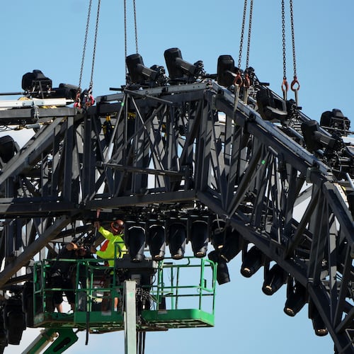A worker on a lift uses a sledge hammer as crews work to disassemble the structure that was built for UFC Freedom 250 at the White in Washington, Sunday, June 21, 2026. (AP Photo/Mark Schiefelbein)