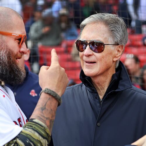FILE - From left, former Red Sox player Jonny Gomes, team owner John Henry, and his wife Linda Pizzuti Henry, talk on the field before a Red Sox baseball game against the Detroit Tigers, April 20, 2026, in Boston. (AP Photo/Jim Davis, File)