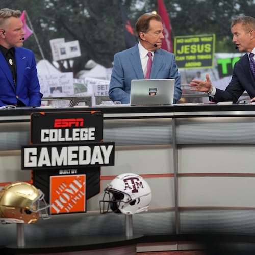 FILE - From left, Pat Mcafee, Nick Saban and Kirk Herbstreit talk on the set of ESPN College Gameday on Saturday, Aug. 31, 2024, in College Station, Texas. (AP Photo/Sam Craft, File)