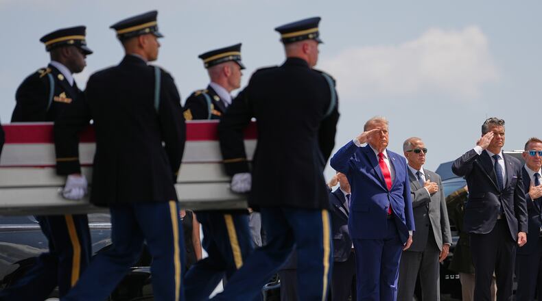 President Donald Trump and Secretary of Defense Pete Hegseth, salute as a U.S. Army carry team moves a transfer case containing the remains of Pvt. Isabella Gonzales of Carrollton, Texas, Wednesday, July 22, 2026, at Dover Air Force Base, Del. (AP Photo/Matt Rourke)