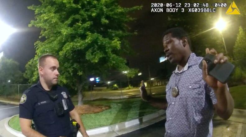 FILE- In this June 12, 2020 file photo from a screen grab taken from body camera video provided by the Atlanta Police Department Rayshard Brooks speaks with Officer Garrett Rolfe in the parking lot of a Wendy's restaurant, in Atlanta. Rolfe has been fired following the fatal shooting of Brooks and a second officer has been placed on administrative duty. The Fulton County District Attorney will announce charging decisions in the fatal shooting of Brooks during a news conference, Wednesday, June 17, 2020 in Atlanta. (Atlanta Police Department via AP, File)