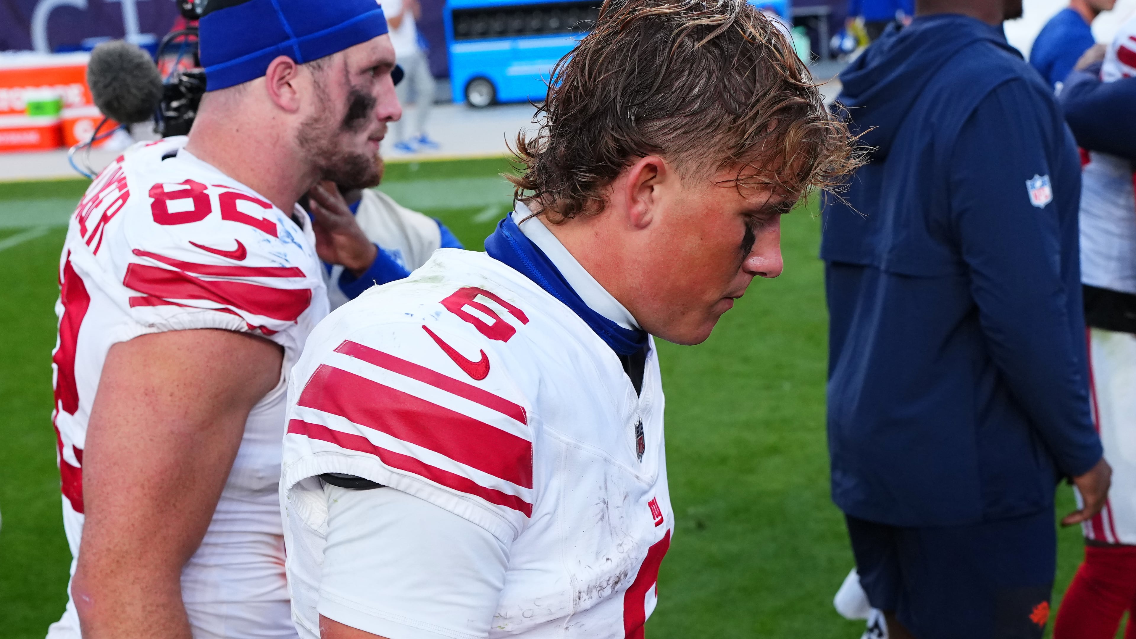 New York Giants tight end Daniel Bellinger, left, and quarterback Jaxson Dart walk off the field after an NFL football game against the Denver Broncos in Denver, Sunday, Oct. 19, 2025. (AP Photo/Jack Dempsey)
