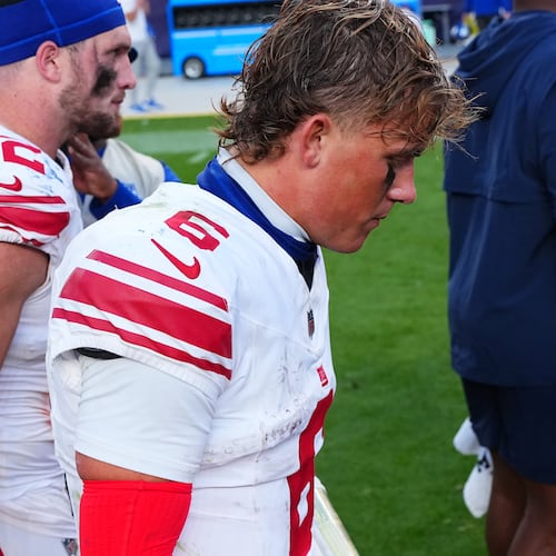 New York Giants tight end Daniel Bellinger, left, and quarterback Jaxson Dart walk off the field after an NFL football game against the Denver Broncos in Denver, Sunday, Oct. 19, 2025. (AP Photo/Jack Dempsey)
